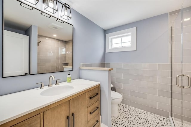 72 Oliver Snow Rd, Harwich, MA 02646 - bathroom with a shower stall, toilet, tile walls, and vanity