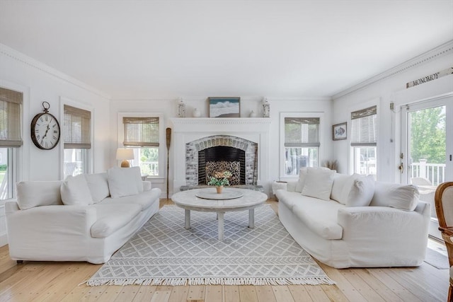 72 Oliver Snow Rd, Harwich, MA 02646 - living room with crown molding, wood-type flooring, and a fireplace