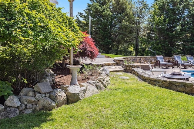 72 Oliver Snow Rd, Harwich, MA 02646 - view of grassy yard with a fire pit and a patio