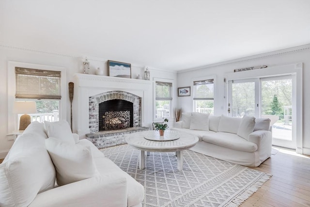 72 Oliver Snow Rd, Harwich, MA 02646 - living area with wood finished floors, a fireplace, and ornamental molding