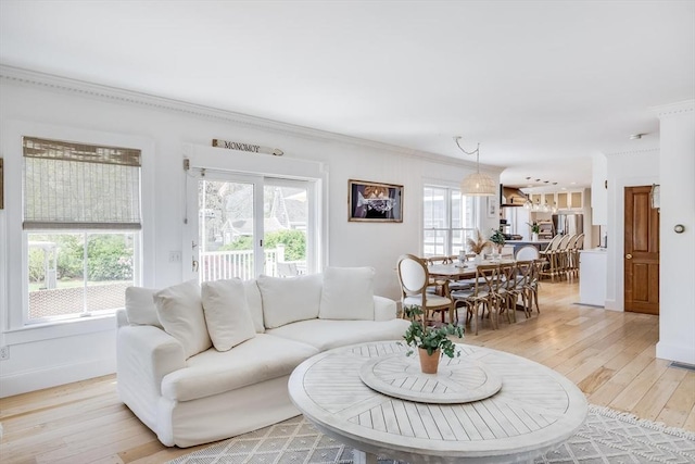 72 Oliver Snow Rd, Harwich, MA 02646 - living area with crown molding, light wood-style flooring, and baseboards