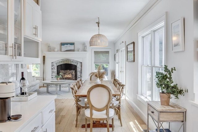 72 Oliver Snow Rd, Harwich, MA 02646 - living area with light wood finished floors, a fireplace, crown molding, and baseboards