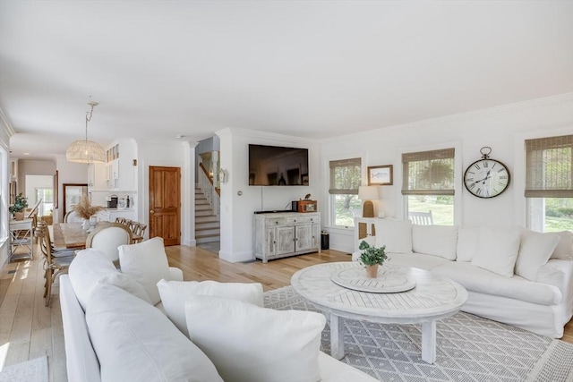 72 Oliver Snow Rd, Harwich, MA 02646 - living room featuring stairway, light wood-style flooring, and ornamental molding