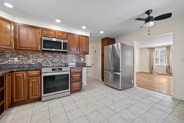 kitchen featuring light tile patterned floors, tasteful backsplash, recessed lighting, appliances with stainless steel finishes, and brown cabinetry