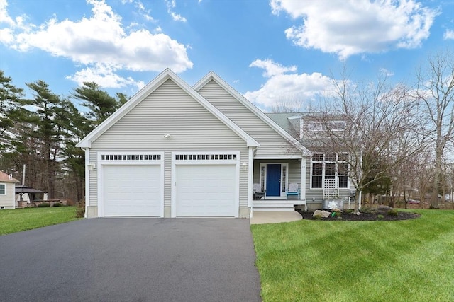 view of front facade with driveway, a front yard, and an attached garage
