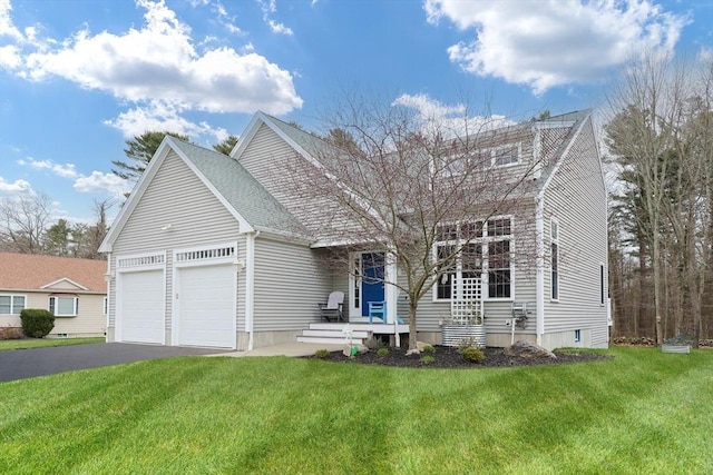 view of front of house featuring a front yard, aphalt driveway, and a garage
