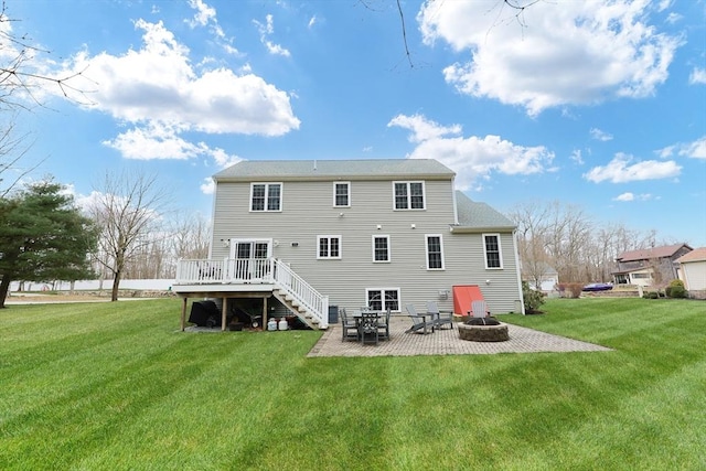 back of house featuring a fire pit, a wooden deck, a patio area, stairway, and a yard