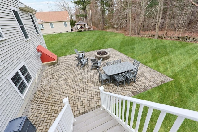 view of patio with outdoor dining area and a fire pit