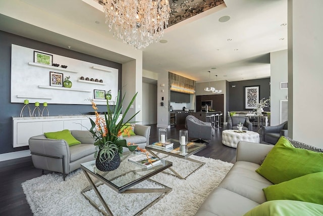 living room featuring wood-type flooring and an inviting chandelier