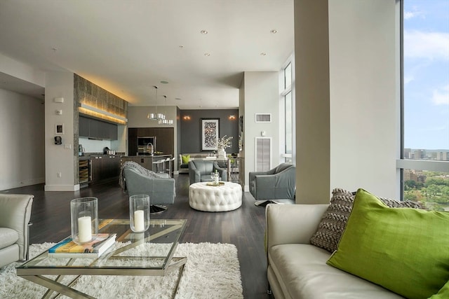 living room featuring hardwood / wood-style floors, a notable chandelier, and a healthy amount of sunlight