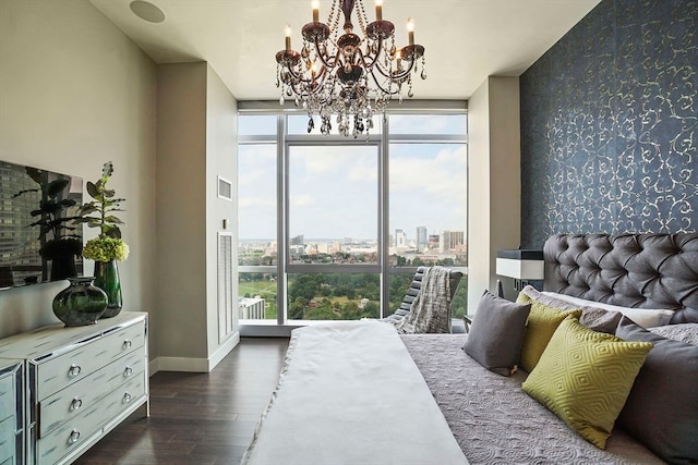 bedroom featuring dark wood-type flooring, a wall of windows, and multiple windows