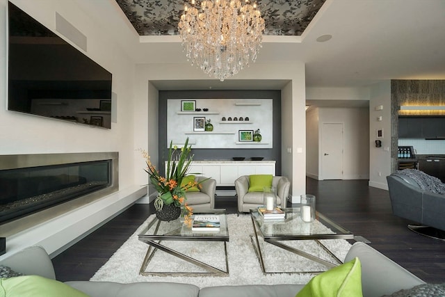 living room featuring dark hardwood / wood-style floors and a notable chandelier