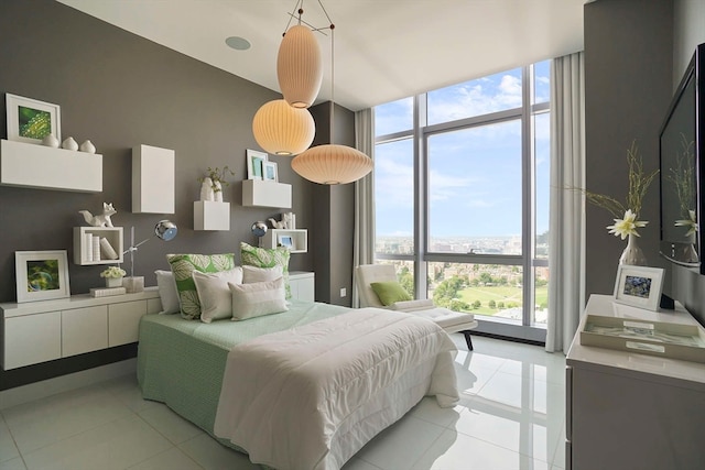 bedroom featuring floor to ceiling windows and light tile patterned flooring