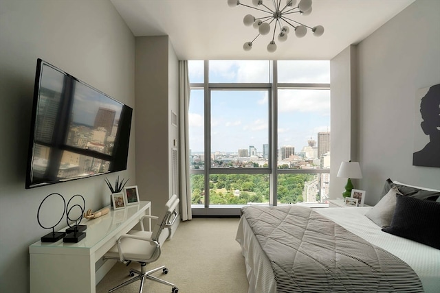 bedroom featuring a chandelier, floor to ceiling windows, and light colored carpet