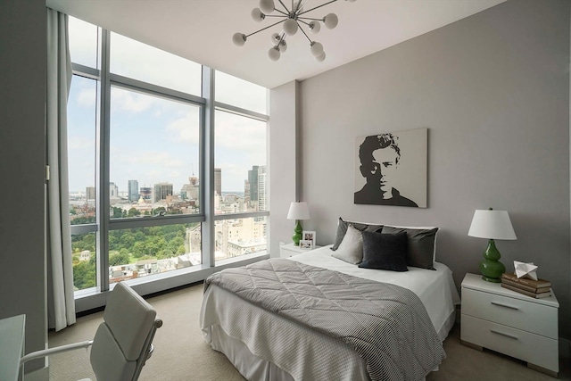 carpeted bedroom featuring an inviting chandelier