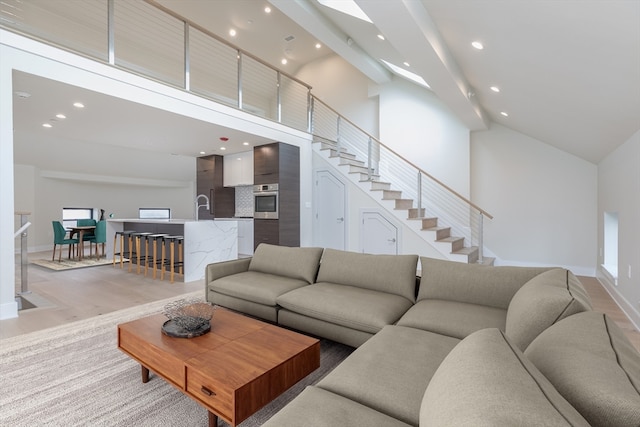 living room with high vaulted ceiling and hardwood / wood-style flooring