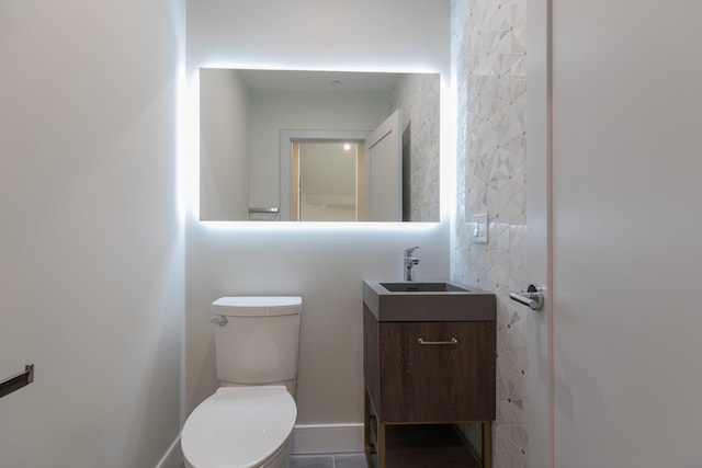 bathroom with tile patterned floors, vanity, and toilet