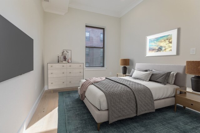 bedroom featuring ornamental molding and hardwood / wood-style floors