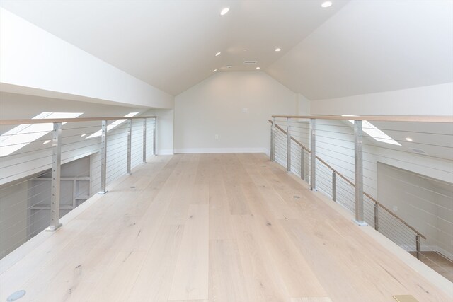 bonus room featuring light hardwood / wood-style flooring and vaulted ceiling