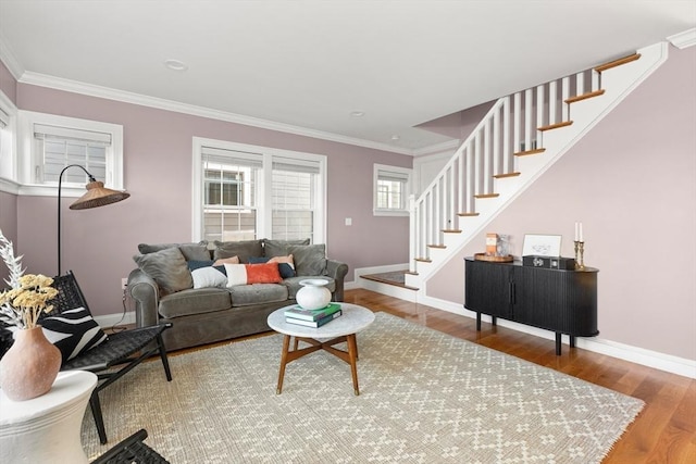 living room with baseboards, stairway, crown molding, and wood finished floors