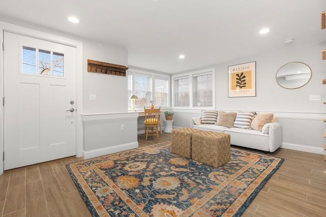 living room featuring baseboards, wood finished floors, and recessed lighting