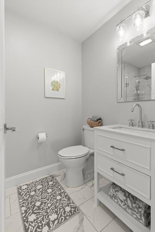 bathroom with toilet, vanity, baseboards, marble finish floor, and walk in shower