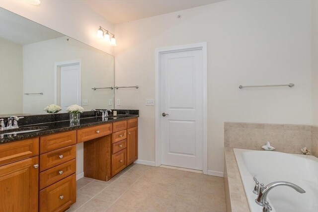 25 Kelly Way Unit 25, Canton, MA 02021 - full bathroom with double vanity, a relaxing tiled tub, tile patterned floors, and baseboards