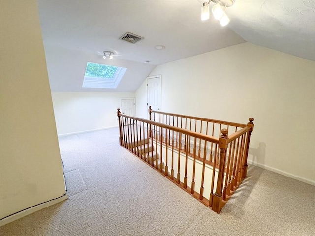 23 Hobart Ln Unit 23, Rockland, MA 02370 - additional living space with vaulted ceiling, carpet, a skylight, baseboards, and a ceiling fan