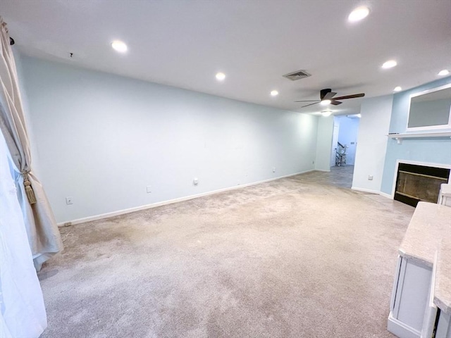23 Hobart Ln Unit 23, Rockland, MA 02370 - unfurnished living room featuring light carpet, ceiling fan, a glass covered fireplace, recessed lighting, and baseboards