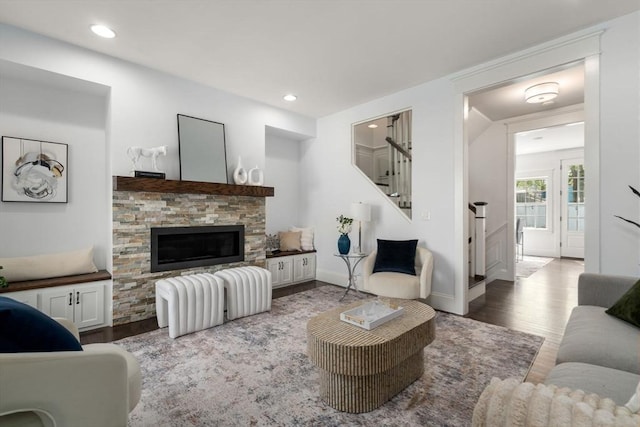 23 Troy Ln Unit 23, Newton, MA 02468 - living room with wood finished floors, a stone fireplace, stairway, baseboards, and recessed lighting