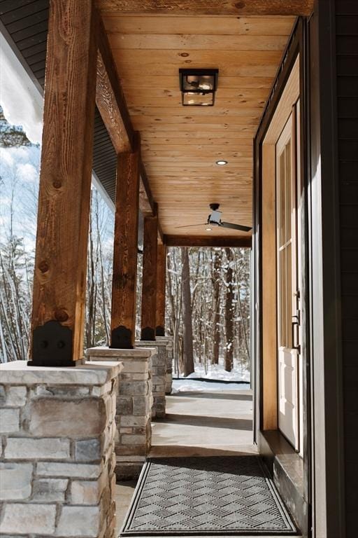 snow covered patio with a porch