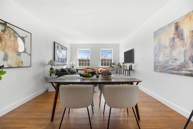 dining area featuring wood finished floors and baseboards