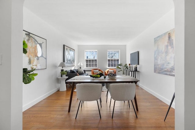 dining area featuring baseboards and wood finished floors