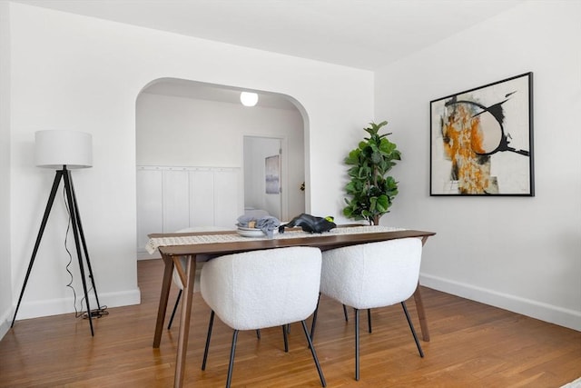 dining area with baseboards and wood finished floors