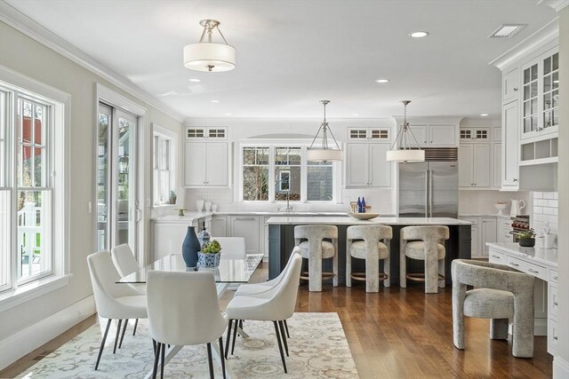 dining space featuring dark wood-type flooring, recessed lighting, and a wealth of natural light