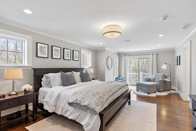 bedroom featuring dark wood-style floors, visible vents, and multiple windows