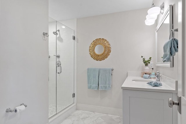 full bath with vanity, marble finish floor, baseboards, and a shower stall