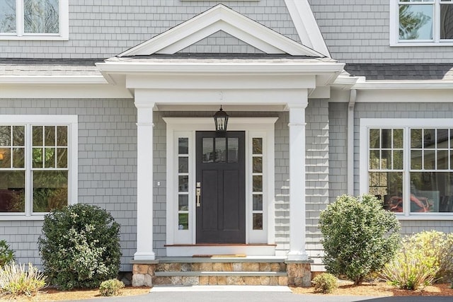 entrance to property with a shingled roof