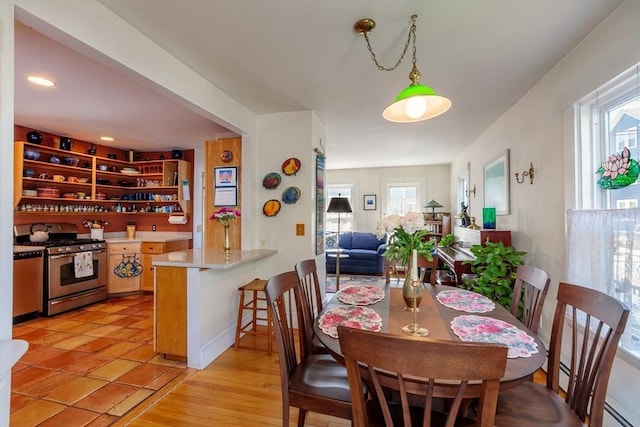 dining area with a baseboard radiator and recessed lighting