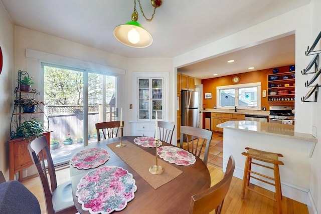 dining area featuring recessed lighting and light wood-style flooring