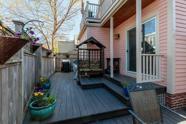 wooden terrace featuring a fenced backyard