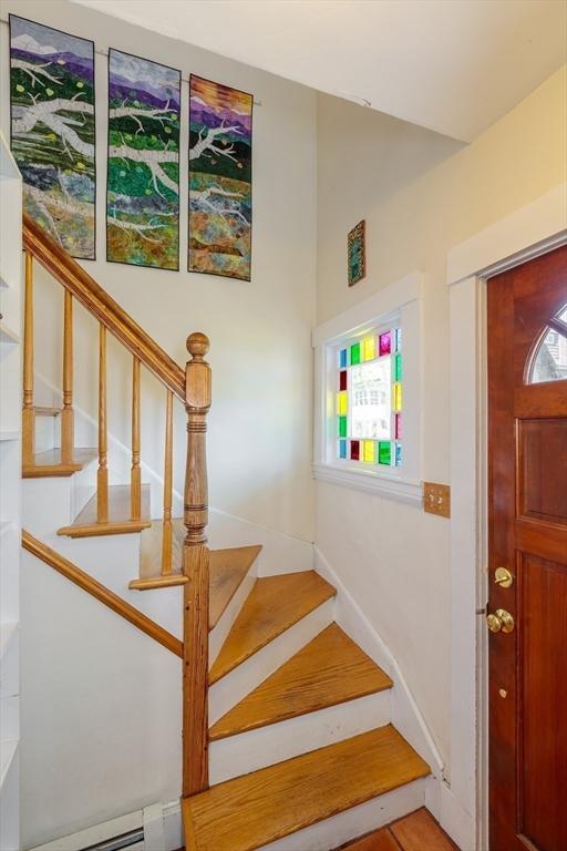 staircase with a baseboard radiator