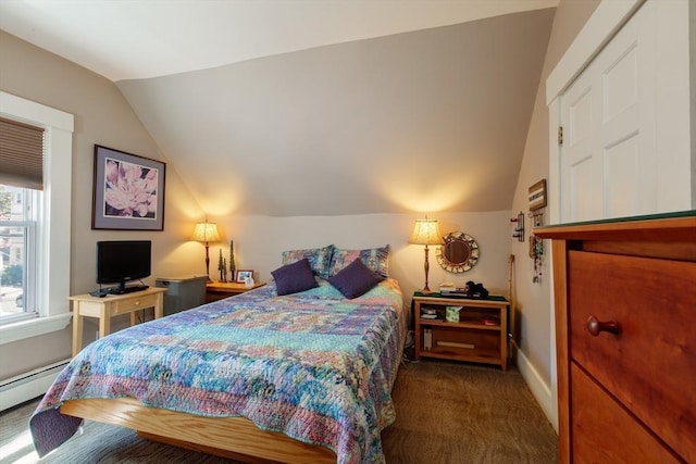 carpeted bedroom featuring vaulted ceiling, baseboard heating, and baseboards