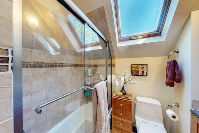 bathroom featuring a skylight, toilet, vaulted ceiling, and tiled shower