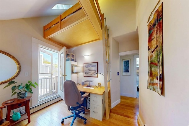 office space with light wood finished floors, baseboards, and baseboard heating