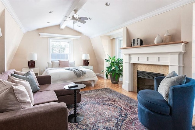 bedroom with light wood-style flooring, a fireplace, crown molding, baseboards, and a ceiling fan