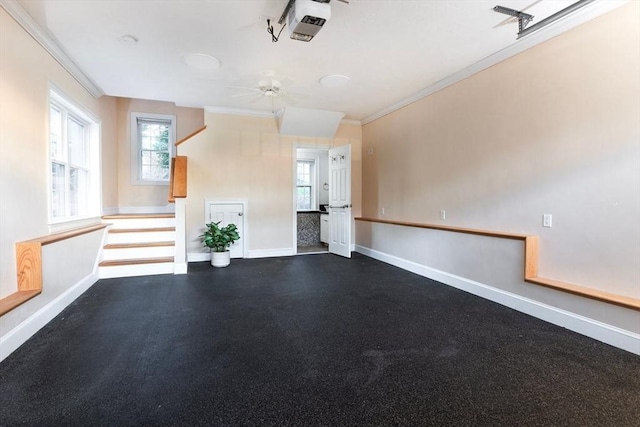 garage featuring baseboards, a garage door opener, and a ceiling fan