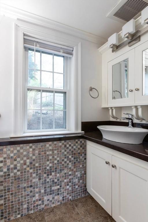 bathroom featuring crown molding, vanity, and tile patterned floors