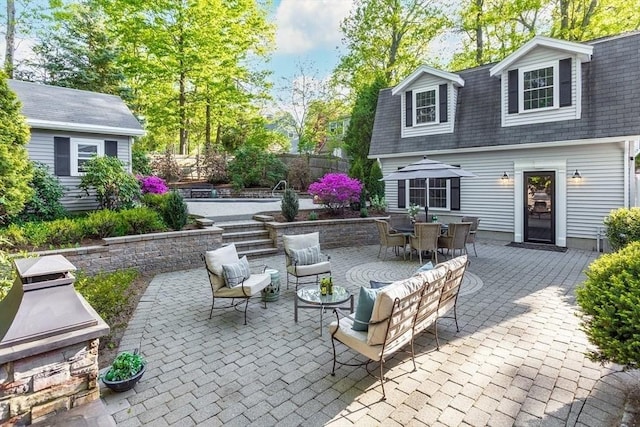 view of patio featuring fence, outdoor dining space, and area for grilling