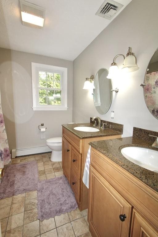 14 Oak Cir, Princeton, MA 01541 - bathroom with a baseboard heating unit, two vanities, and lofted ceiling